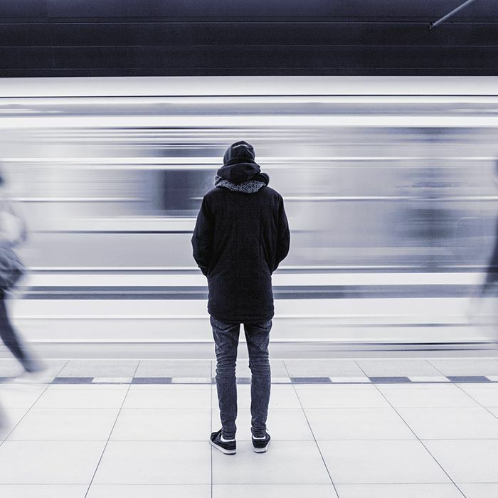 Person standing in front of a subway going by