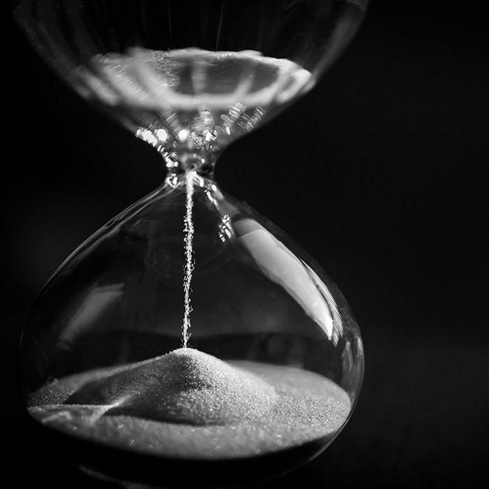 Close up hourglass sand almost done