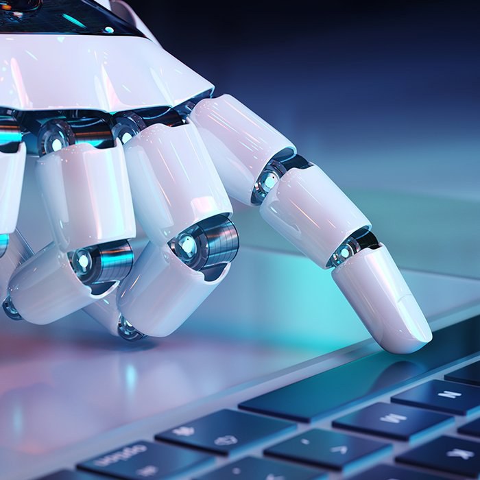 Up close robot finger extended pushing button on keyboard