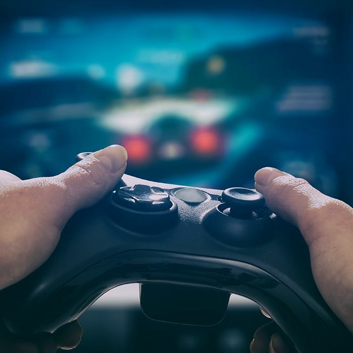 Up close two thumbs on a video game controller