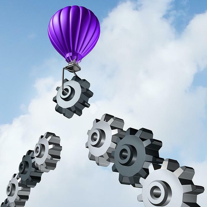 Purple air balloon in sky with gears reaching up and letting it go