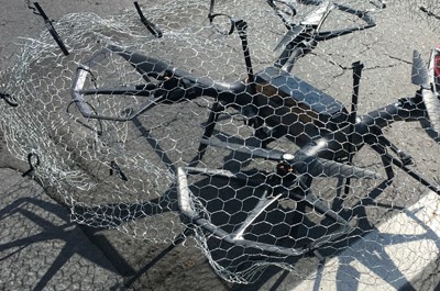 Blog post on Drone security defense measures showing a drone caught into chicken wire and stuck to the ground.