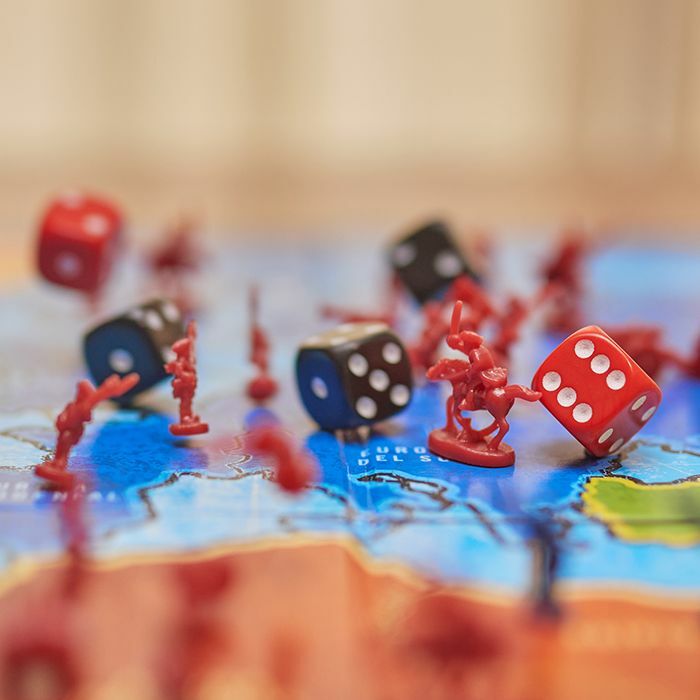 Upclose red pieces and dices on game board