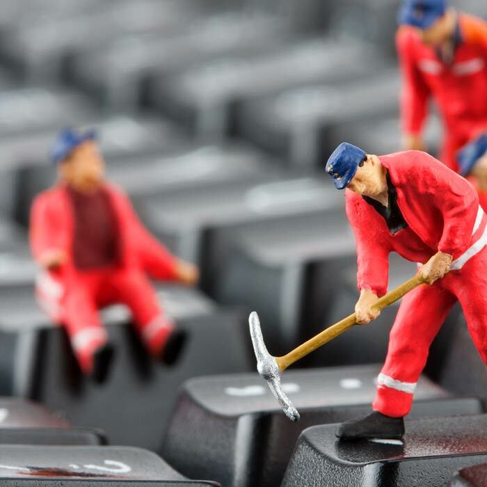 Three small toy men in red uniforms with blue hats taking a pickaxe at a keyboard and talking about red teaming engagements.