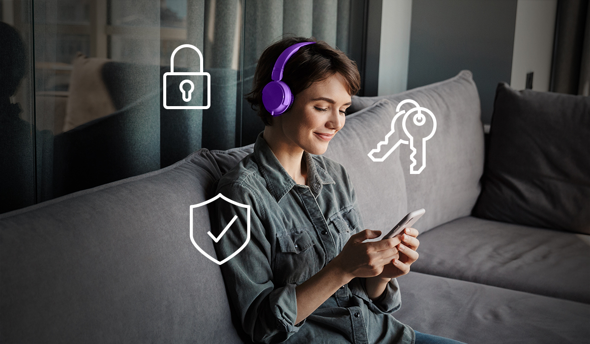 Woman on couch using cell phone headphones on