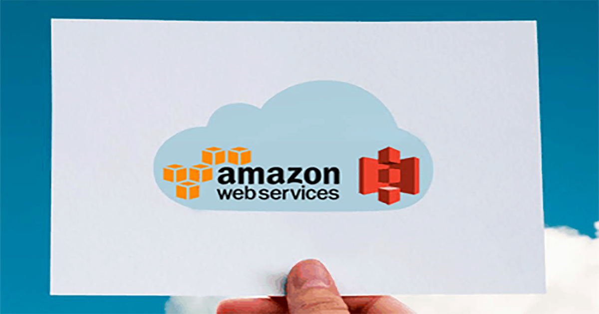 Hand holding white card with amazon web services printed on it