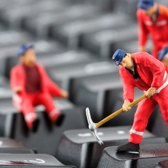 Three small toy men in red uniforms with blue hats taking a pickaxe at a keyboard and talking about red teaming engagements.