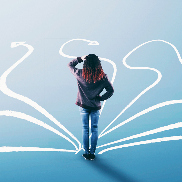 Girl standing in front of chalk drawings on ground